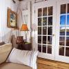 Reused and repositioned windows and doors capture lakeside views and breezes. 