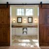 Custom barn doors create a dramatic entrance to the master bath.